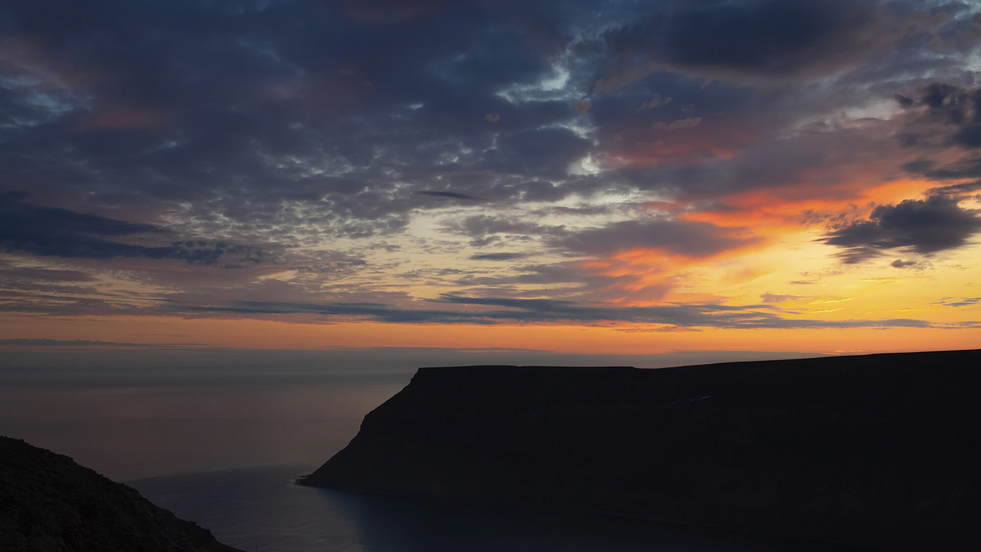 The cliffs of Suðureyri at sunset